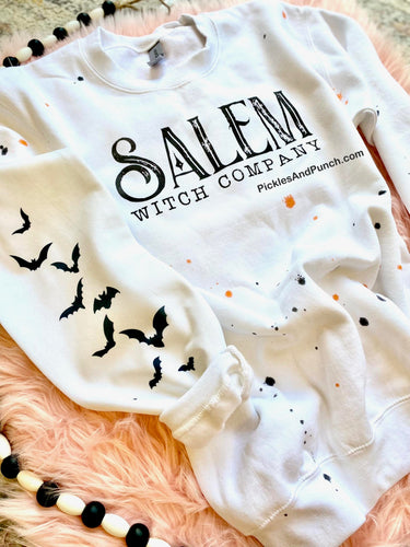Salem Witch Company Halloween Splatter w/ Bats On Sleeve Sweatshirt. orange and black halloween splatter witches 