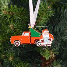 Load image into Gallery viewer, Oh no!  Santa&#39;s Out of Gas in his Vintage Old Timey Pickup Truck with Christmas Tree in the Back.  PREORDERS WILL NOT ARRIVE UNTIL MID TO LATE OCTOBER.  PLEASE PUT ALL PREORDERS ON THEIR OWN ORDER, OTHERWISE YOUR OTHER ITEMS WILL WAIT TO SHIP UNTIL YOUR ORNAMENT(S) COME IN.  THANK YOU!   Soft enamel with a gold metal backing * Measures about 3 inches in height * velvet ribbon to hang (Color may change from our sample image color)